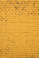 Yellow brick wall close up vertically. Yellow background. Construction and architecture.