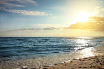 Picturesque view of beautiful sky with clouds over tropical beach at sunset
