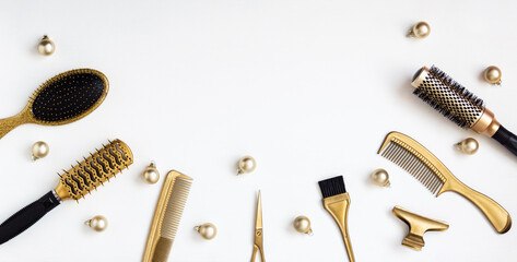 Banner with hairdressing tools in gold color and Christmas balls on a white background. A holiday template with accessories for a hair salon with space for text. Flat lay with Hairstylists scissors