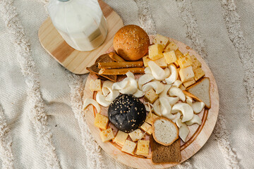 High angle view of cheese assortment, bread and milk. Outdoor food photography of cheese buffet