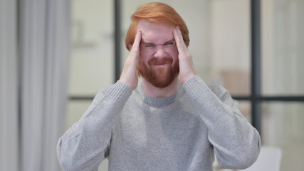 Young Beard Redhead Man having Headache