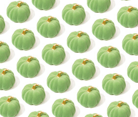 Creative pattern for Halloween with green pumpkins. 