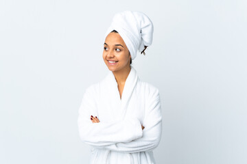 Young woman in bathrobe over isolated white background looking side