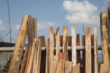 A group of woods against the blue sky was cut from Indonesian local gardens for building materials.