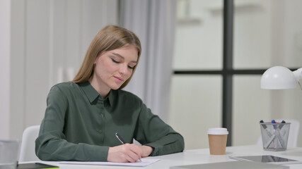 Pensive Young Woman Writing on Paper, Thinking 