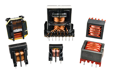 Set of isolation transformers with copper wire on inductors isolated on a white background....