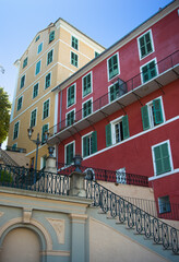 Colorful yellow and red buildings in the town of Bastia in Corsica on a summer day with a blue sky.