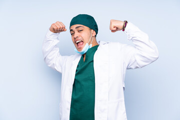 Surgeon man with uniform isolated on blue background celebrating a victory