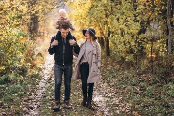 Family with a little son in autumn park