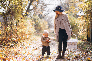 Fototapeta premium Mother with her little son in autumn park