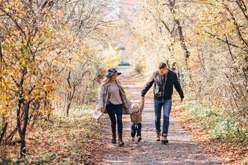Fototapeta premium Family with a little son in autumn park