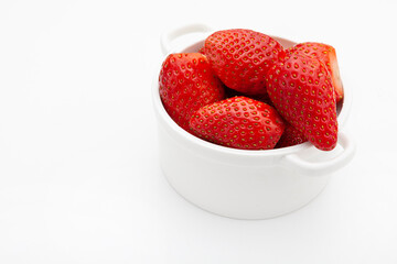 strawberries in  white a bowl on a white background