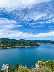Fototapeta na wymiar Overhead view looking over Mountain Lake arrowhead Southern California with blue skies and cloudscape