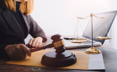 justice and law concept.Male judge in a courtroom on wooden table and Counselor or Male lawyer...