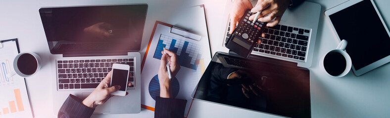 Business women working together at office desk, hands close up with calculator out financial data. teamwork workplace strategy Concept.