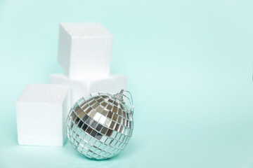Simply minimal composition winter object ornament and cube shapes geometric form podium isolated blue pastel background. Christmas New Year december time for celebration concept. Mockup, copy space