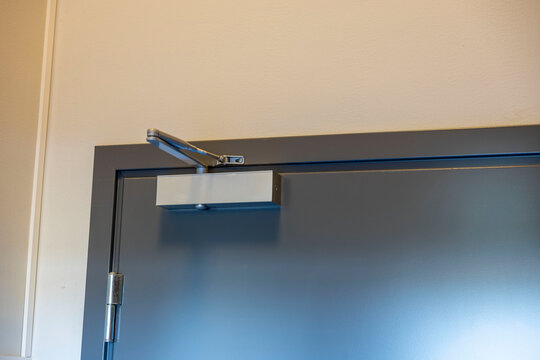 Close Up View Of Extra Heavy Aluminum Commercial Door Closer. Technology Background. Sweden.