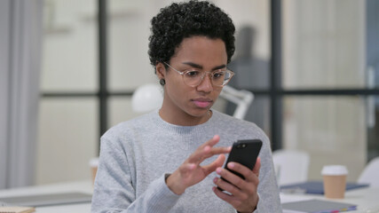 Fototapeta na wymiar African Woman Browsing internet on Smartphone