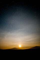 Fototapeta na wymiar Moonrise over Snaefell Mountain, Isle of Man on a clear evening