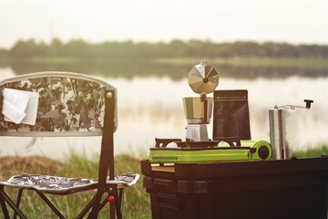 Coffee brewing outdoors with nature. vintage style. Camping on green lawn. Relax day.