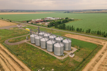 Fototapeta na wymiar Grain elevator in agricultural zone. Aerial view of Grain storage warehouse