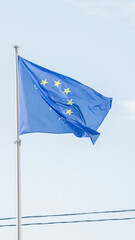European Union flag flying on the blue sky