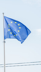 European Union flag flying on the blue sky