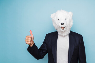 Man with polar bear mask making finger up gesture.