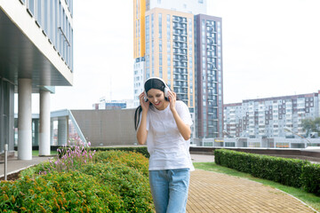 teen girl enjoying music with headphones outdoors