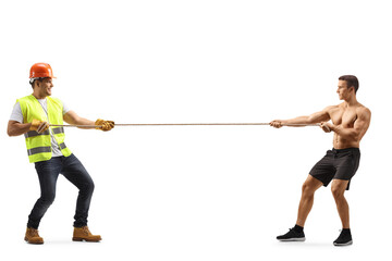 Full length profile shot of a construction worker and a bodybuilder pulling a rope