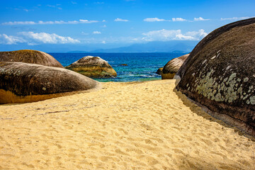 Paradisiacal beach of green and transparent waters surrounded by rocks in Ilha Grande, Angra dos...