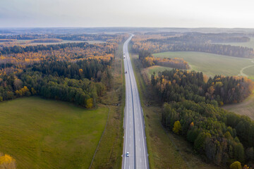 Aerial view of freeway road in autumn forest.