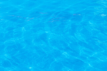Blue clear pool water with abstract pattern of reflection and wave surface background