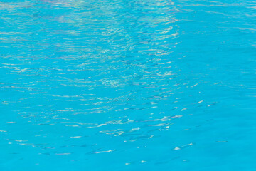 Blue clear pool water with abstract pattern of reflection and wave surface background