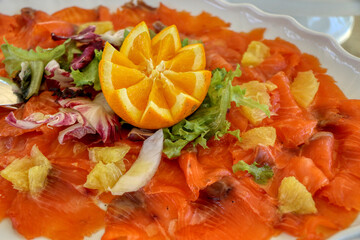 Orange marinated smoked salmon dish and salad