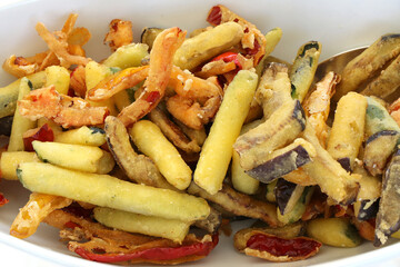 Fried breaded vegetable. Peppers, courgettes, carrots, peppers and aubergines marinated with oil and parsley