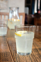 Glass of lemonade on the wooden table