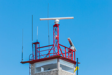 Safety and security post or tower pier sea symbol and landmark against the blue sky