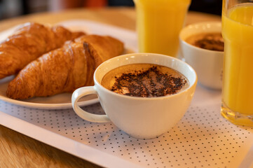 French breakfast with fresh baked croissants, coffee and orange juice