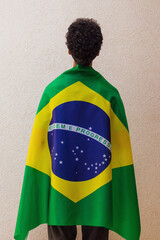 Back of a man with Brazilian flag hero cape. Flag and Independence Day Concept Image.