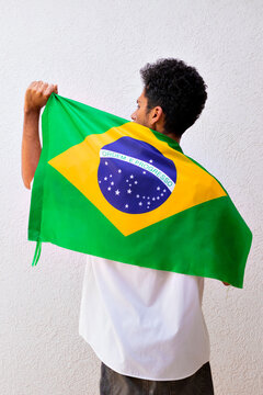 Business or Worker Holding a Brazil Flag Isolated On White. Flag and Independence Day Concept Image.