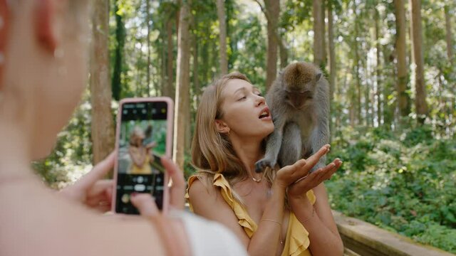 travel woman posing for photo with monkey sitting on shoulder best friend using smartphone photographing playful monkeys sharing wildlife adventure