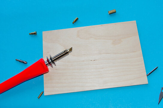 A pyrographyl, on a blue background, free space for insertion, ready-made background for advertising.selective focus
