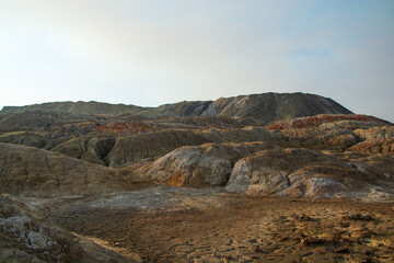 The clay quarry resembles a cosmic landscape.Ural Mars.Top view of the hills made of refractory colored clay.