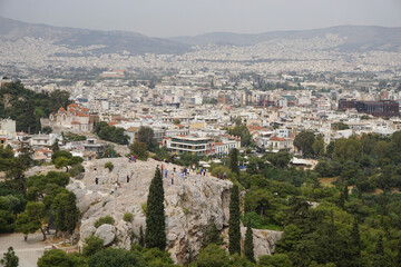 Fototapeta na wymiar Athens, Greece: View from the Acropolis of the Athens skyline and the Areopagus (Ares Rock), under a hazy sky caused by dust clouds.