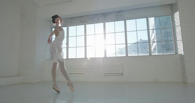 Agile ballet dancer does graceful jumps. Choreographer preparing for a performance. Slender girl practicing moves arts concept 4k footage