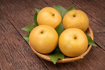 Snow pear or Shingo pear on a wooden background, Nashi pear fruits delicious and sweet on wooden background.