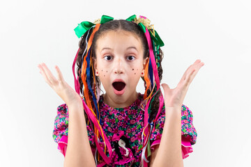 Brazilian little girl dressed for June party  são João carnival happy and excited in studio with white background