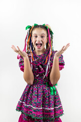Brazilian little girl dressed for June party, carnival, são João , happy and excited in studio with white background.