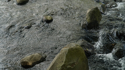 The river flows between the rocks